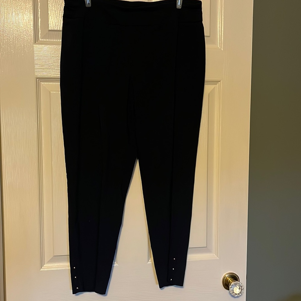 Navy blue stretch slacks with gold studs at ankle.